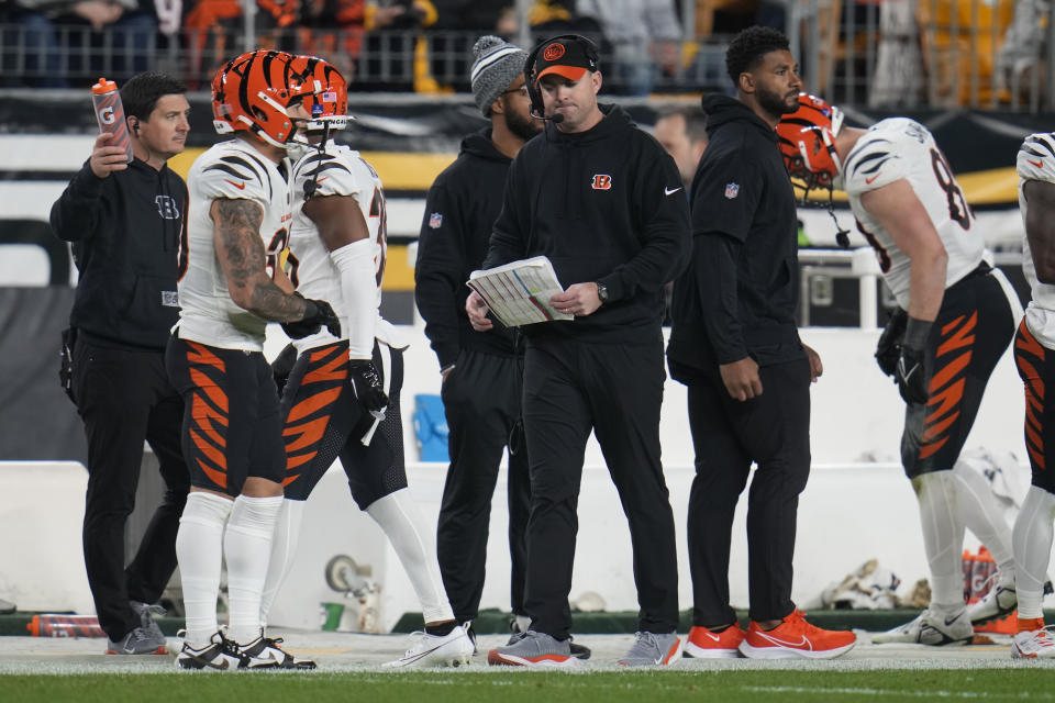 Cincinnati Bengals head coach Zac Taylor, center, walks the sideline during the second half of an NFL football game against the Pittsburgh Steelers, Saturday, Dec. 23, 2023, in Pittsburgh. (AP Photo/Gene J. Puskar)
