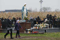 <p>People visit a cemetery in Lomna near Warsaw, Poland, Wednesday, Nov. 1, 2017. Candles and flowers cover tombstones in graveyards across Poland on All Saints’ Day. (Photo: Czarek Sokolowski/AP) </p>