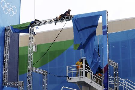 Rio Olympics - Diving - Olympic Park - Rio de Janeiro, Brazil - 07/08/2016. Workers repair damage caused by high winds at the Olympic diving venue. REUTERS/Stefan Wermuth