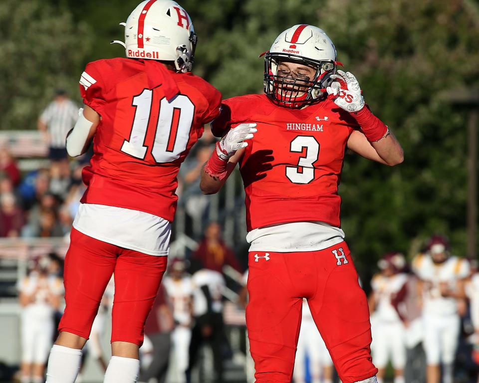 Hingham's Nicholas Kraus and Hingham's Johnny Heffernan celebrate the fumble recovery by Hingham's Jayce Mellish during fourth quarter action of their game against Weymouth at Hingham High on Saturday, Sept. 24, 2022.