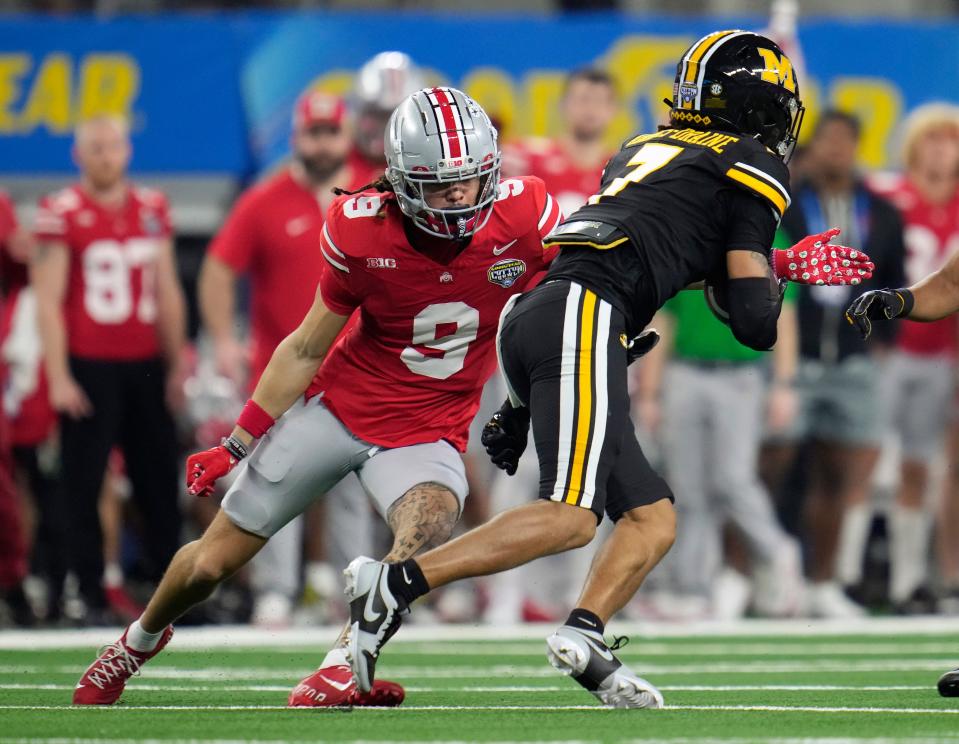 Dec 29, 2023; Arlington, Texas, USA; Ohio State Buckeyes wide receiver Jayden Ballard (9) tackles Missouri Tigers defensive back Kris Abrams-Draine (7) on a punt return in the second quarter during the Goodyear Cotton Bowl Classic at AT&T Stadium.
