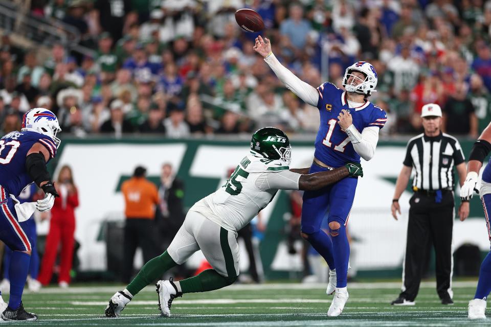 EAST RUTHERFORD, NEW JERSEY - SEPTEMBER 11: Quarterback Josh Allen #17 of the Buffalo Bills throws an interception on a deep pass under pressure from defensive tackle Quinnen Williams #95 of the New York Jets during the third quarter of the NFL game at MetLife Stadium on September 11, 2023 in East Rutherford, New Jersey. (Photo by Elsa/Getty Images)