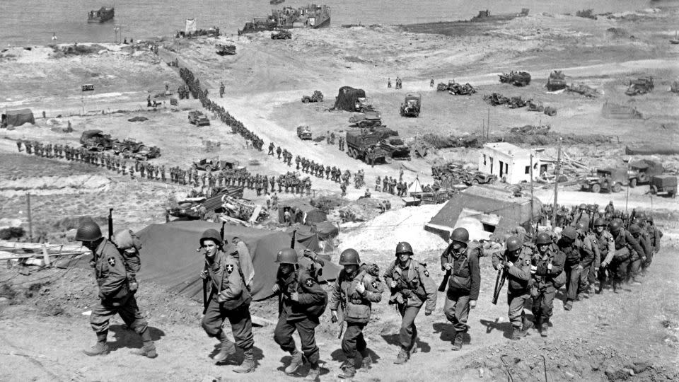 American troops march up from Omaha Beach on June 18, 1944. - Underwood Archives/Getty Images