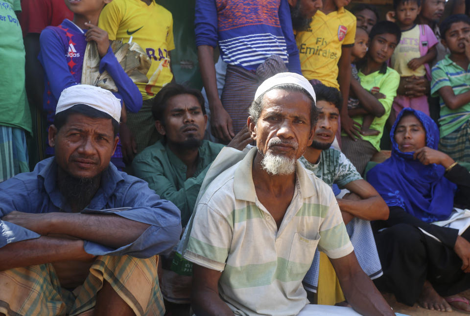 In this Wednesday, April 1, 2020, photo, Rohingya refugees watch at the Kutupalong refugee camp, Cox’s Bazar, Bangladesh. Aid workers are bracing for a possible outbreak of the coronavirus in one of the world's largest refugee camps in Bangladesh, but officials are already warning that containing the disease among more than 1 million tightly packed Rohingya Muslims will be a daunting task. (AP Photo/Suzauddin Rubel)