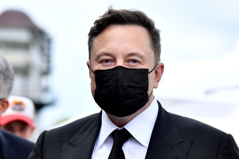 FILE PHOTO: Elon Musk wears a protective mask as he arrives to attend a meeting with the leadership of the conservative CDU/CSU parliamentary group, in Berlin