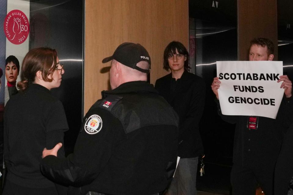 Protesters are escorted out of the Four Seasons Hotel by the Police after interrupting the Scotiabank Giller Prize ceremony in Toronto, on Monday, November 13, 2023.