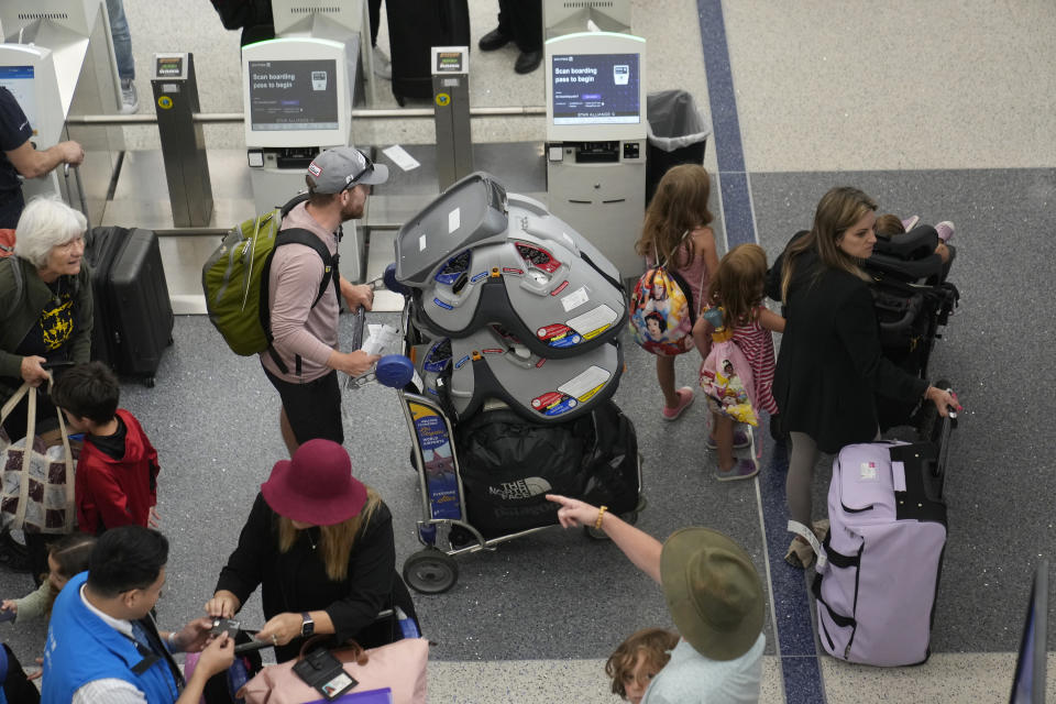 Travelers wait in line at the departure area check-in at the United Airlines terminal at Los Angeles International Airport, Wednesday June 28, 2023, in Los Angeles. Travelers waited out widespread delays at U.S. airports on Tuesday, an ominous sign heading into the long July 4 holiday weekend, which is shaping up as the biggest test yet for airlines that are struggling to keep up with surging numbers of passengers. (AP Photo/Damian Dovarganes)