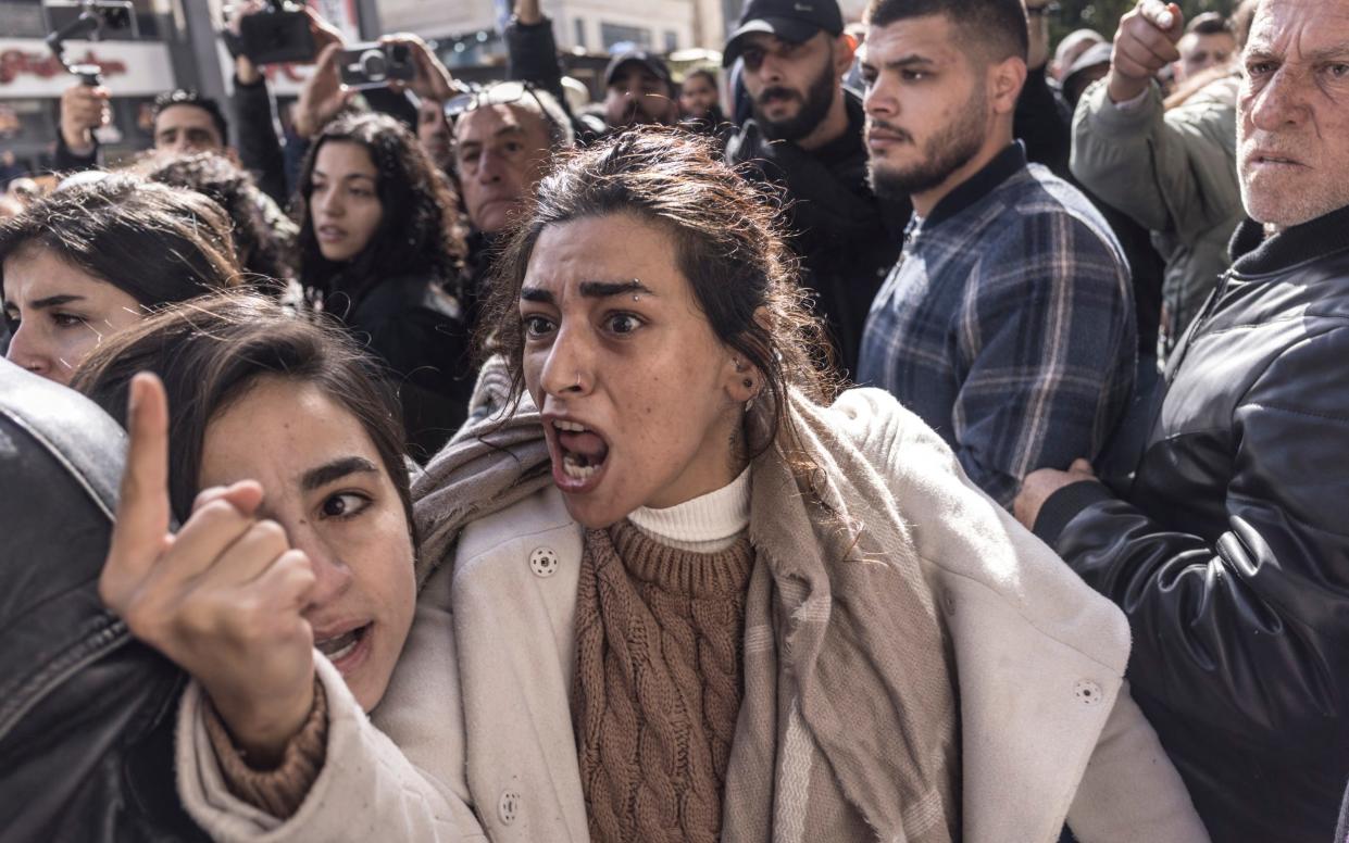 A protester reacts as demonstrators are confronted by Palestinian Authority security forces during a protest held in Ramallah as US Secretary of State Antony Blinken met with the Palestinian president