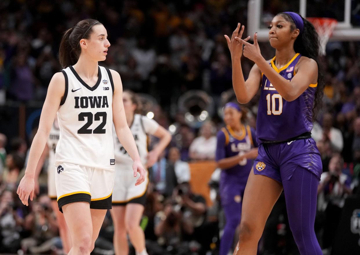 Angel Reese (10) shows Iowa Caitlin Clark her ring finger during the final seconds of the women's NCAA Tournament national championship game.