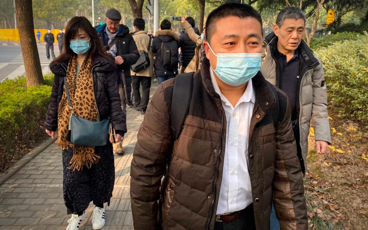 Lawyer Ren Quanniu (C), representing Chinese citizen journalist Zhang Zhan who reported on Wuhan's Covid-19 outbreak  - AFP