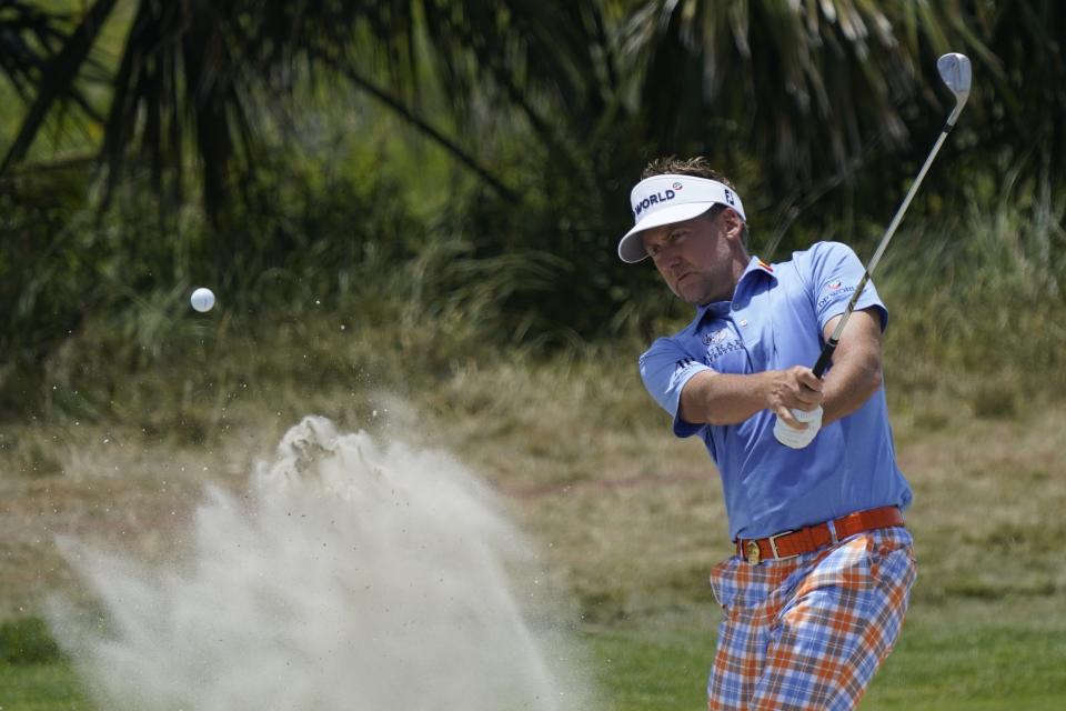 Ian Poulter, of England, works in the bunker on the fourth hole during the third round at the PGA Championship golf tournament on the Ocean Course, Saturday, May 22, 2021, in Kiawah Island, S.C. (AP Photo/Matt York)