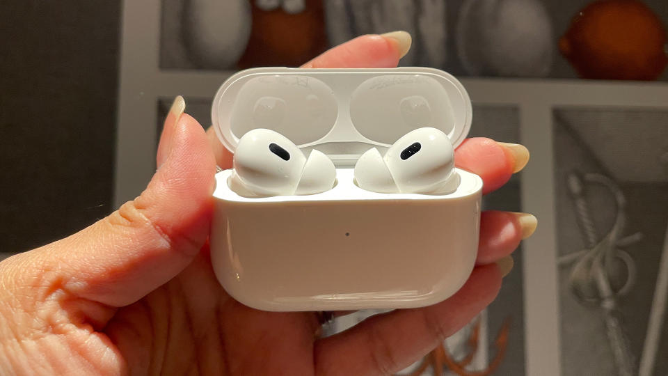 Apple AirPods Pro 2 being held in the case