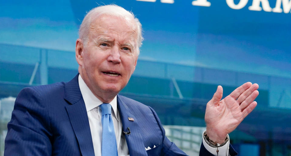 President Joe Biden making speech with hand out