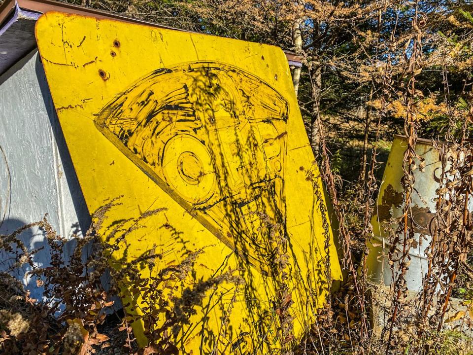 An old provincial police detachment sign sits discarded on the property where officers with the force carried out firearm training for 26 years.