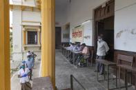 People wait in a queue to give their nasal swab samples to test for COVID-19 in Prayagraj, India, Friday, Aug. 7, 2020. As India hit another grim milestone in the coronavirus pandemic on Friday, crossing 2 million cases and more than 41,000 deaths, community health volunteers went on strike complaining they were ill-equipped to respond to the wave of infection in rural areas. (AP Photo/Rajesh Kumar Singh)