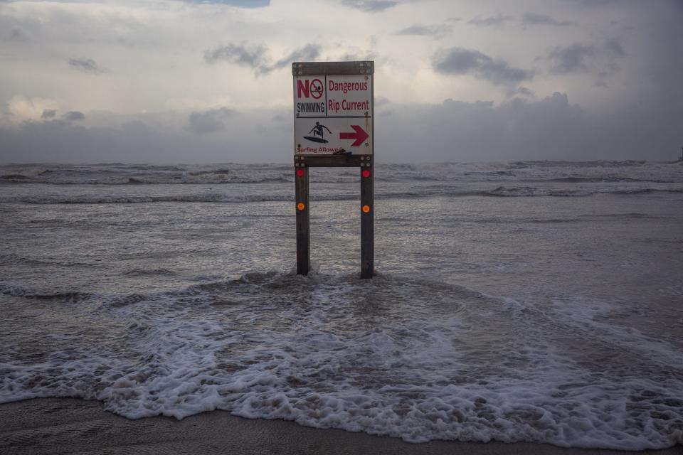 A sign warns beach visitors not to swim or surf due to rip currents caused by Tropical Storm Beryl on Sunday evening, July 7, 2024, in Corpus Christi, Texas.