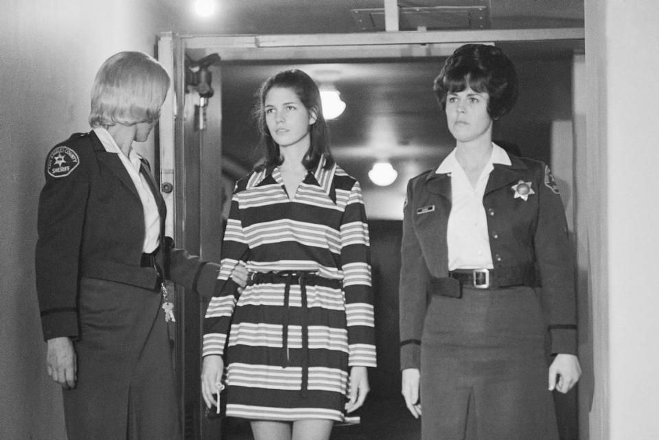 FILE - Leslie Van Houten, 19, a member of Charles Manson’s “family” who is charged with the murders of Leno and Rosemary LaBianca, is escorted by two deputy sheriffs as she leaves the courtroom in Los Angeles, Dec. 19, 1969, after a brief hearing. Van Houten has been released from a California prison after serving 53 years for two infamous murders. The California Department of Corrections and Rehabilitation said Tuesday, July 11, 2023, that Van Houten “was released to parole supervision.” (AP Photo/George Brich, File) George Brich/AP file