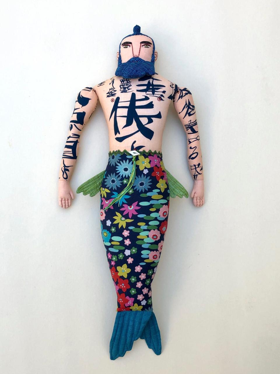 Mimi Kirchner of Arlington's Tattooed Merman doll is soft sculpture taken to the edge. The 2-foot tall one-of-a-kind fabric merman doll is hand embroidered with applique details.