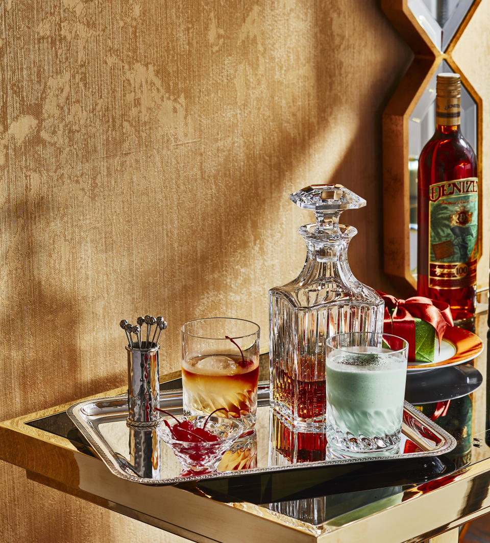 Baccarat’s tumblers, Harmonie’s whiskey decanter, Juliska’s picks and holder and Christofle’s tray.