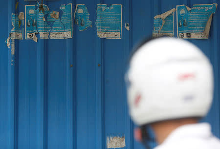 A man stands near posters the Cambodia National Rescue Party (CNRP) on the outskirts of Phnom Penh, Cambodia, November 20, 2017. REUTERS/Samrang Pring