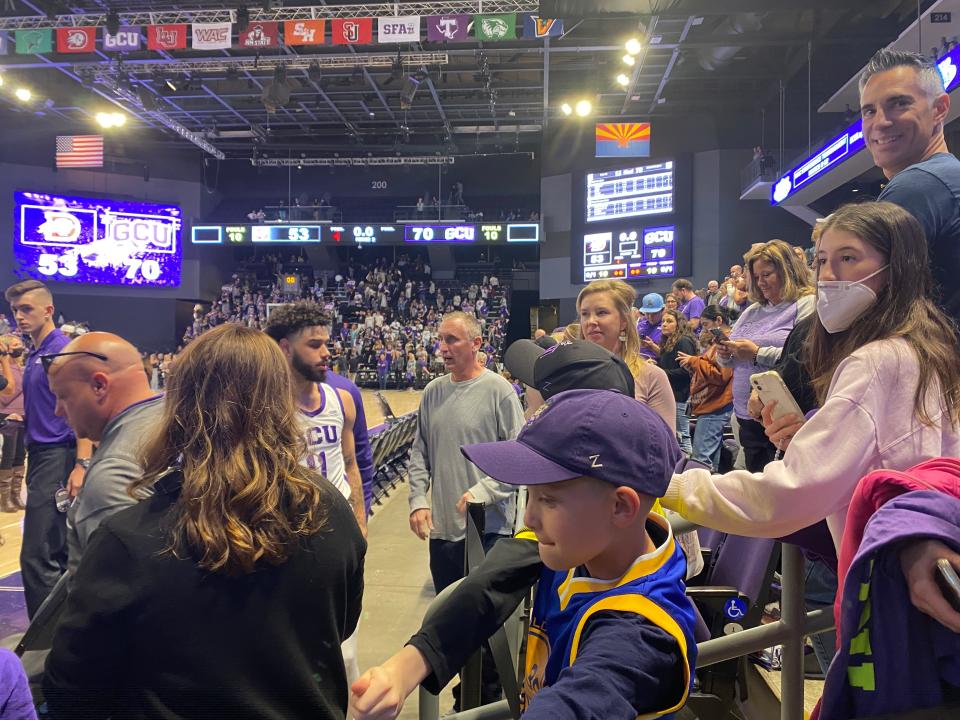 GCU guard Holland Woods II talks with his former coach, ASU head coach Bobby Hurley, before his final regular-season game vs. Dixie State.