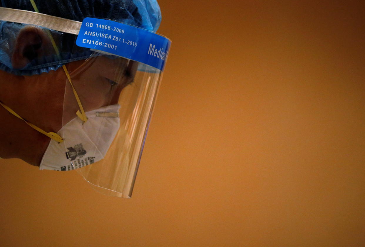 A healthcare worker is pictured at a swabbing station during the coronavirus disease (COVID-19) outbreak in Singapore January 25, 2021. REUTERS/Edgar Su