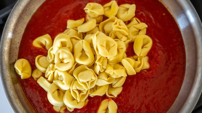 tortellini added to tomato sauce