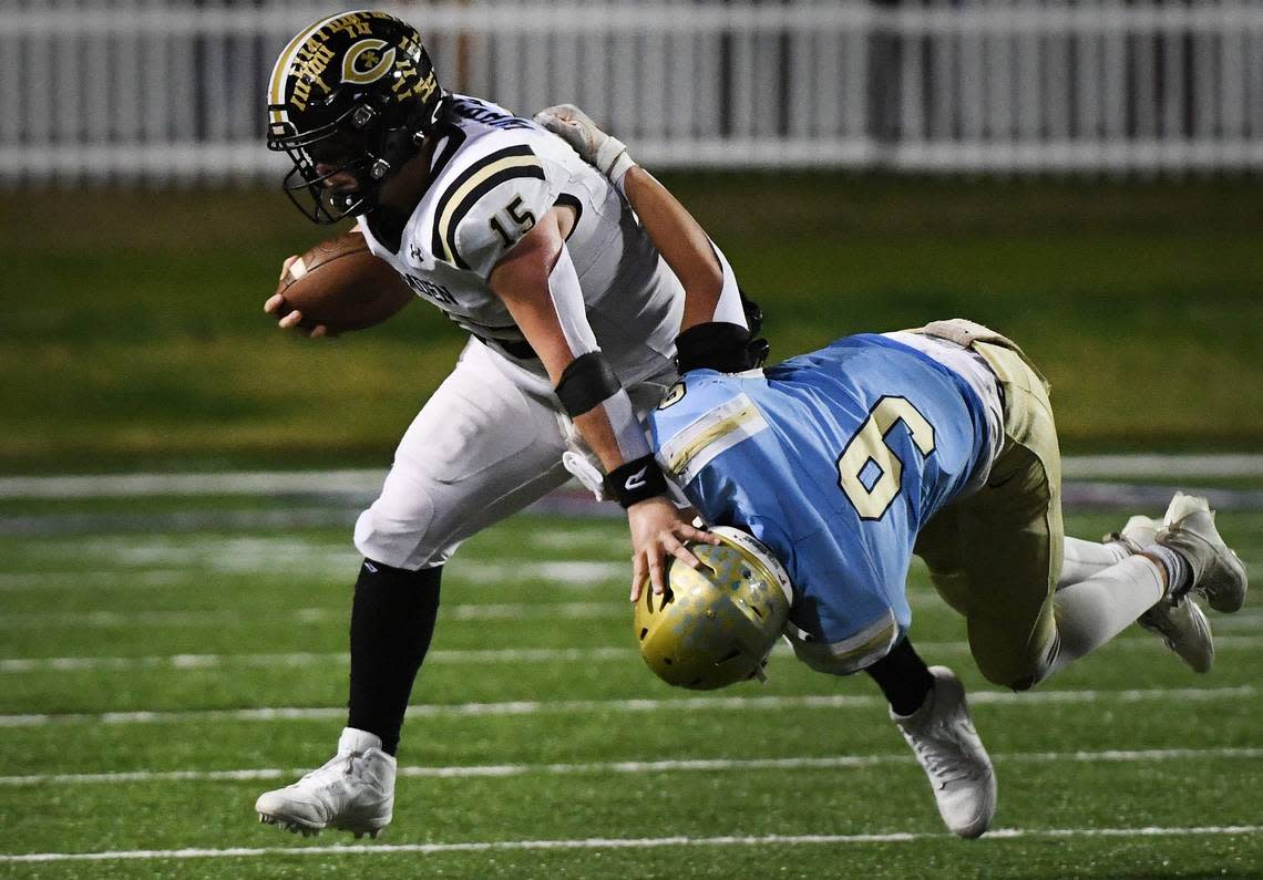 Camden’s Grayson White (15) carries the ball as Daniel’s Ben Joplin (9) try to make the stop in Saturday’s Class 3A championship game played at S.C. State University in Orangeburg.