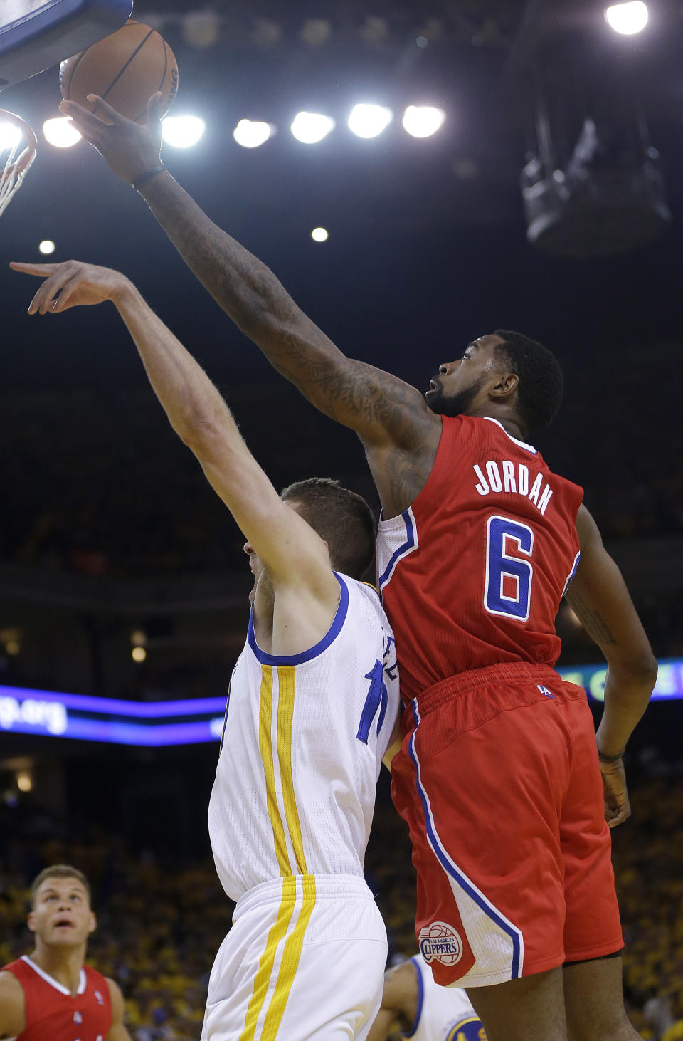 Los Angeles Clippers center DeAndre Jordan (6) reaches for the ball over Golden State Warriors power forward David Lee during the first quarter of Game 6 of an opening-round NBA basketball playoff series in Oakland, Calif., Thursday, May 1, 2014. (AP Photo/Marcio Jose Sanchez)