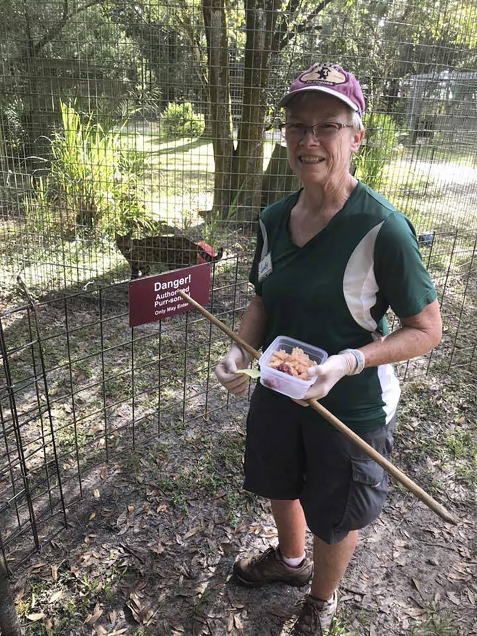 In this 2018 photo provided by Big Cat Rescue, volunteer Candy Couser smiles before feeding big cats at Carole Baskin’s Big Cat Rescue sanctuary near Tampa, Fla. Couser, who regularly feeds big cats was bitten and seriously injured by a tiger Thursday morning, Dec. 3, 2020, at the sanctuary, which was made famous by the Netflix series “Tiger King,” officials said. (Big Cat Rescue via AP)