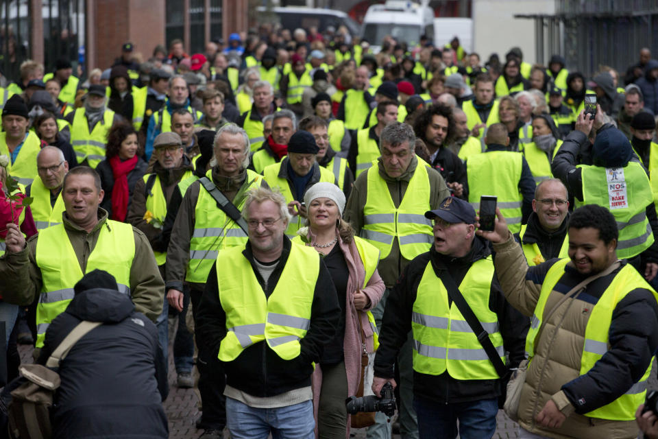 Several hundred demonstrators in yellow vests march during a peaceful demonstration in Amsterdam, Netherlands, Saturday, Dec. 8, 2018. The French yellow vest protest movement is crossing borders, with demonstrations planned in neighboring Belgium and in the Netherlands. Neither country has proposed a hike in fuel tax, the catalyst for the massive and destructive demonstrations in France in recent weeks. (AP Photo/Peter Dejong)