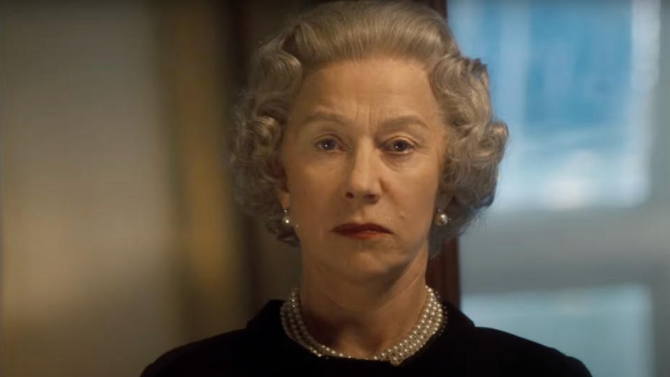 Helen Mirren standing somberly as Queen Elizabeth II in The Queen.