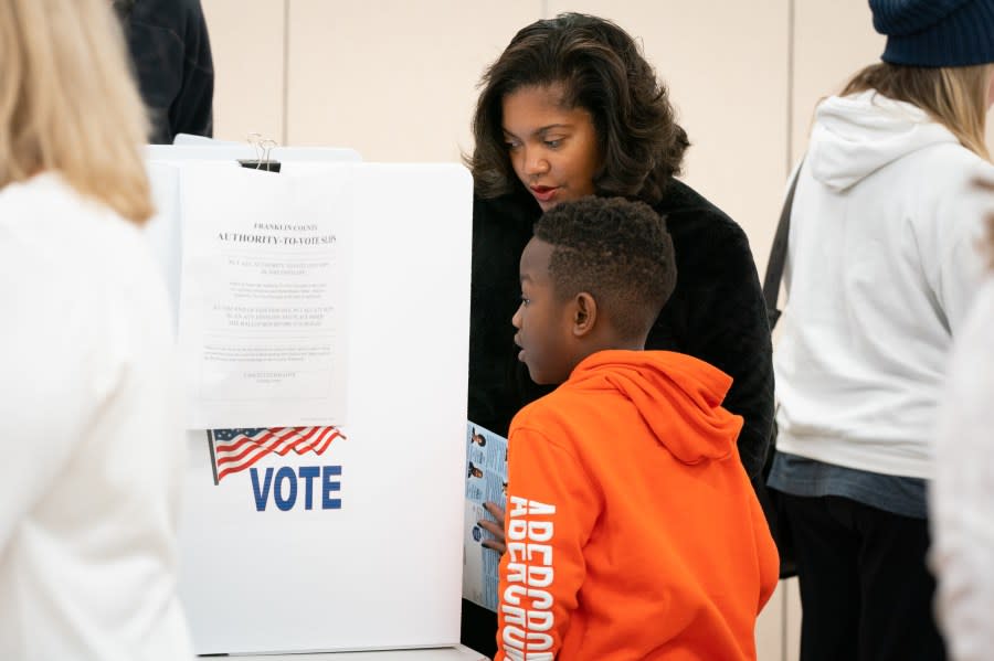 Angela Chapman, 47, of Columbus, Ohio, votes with her 7-year-old son, Noble Johnson-Bey. She is an educator and teaches her son to participate in the democratic process. (Photo by Sarah L. Voisin/The Washington Post via Getty Images)