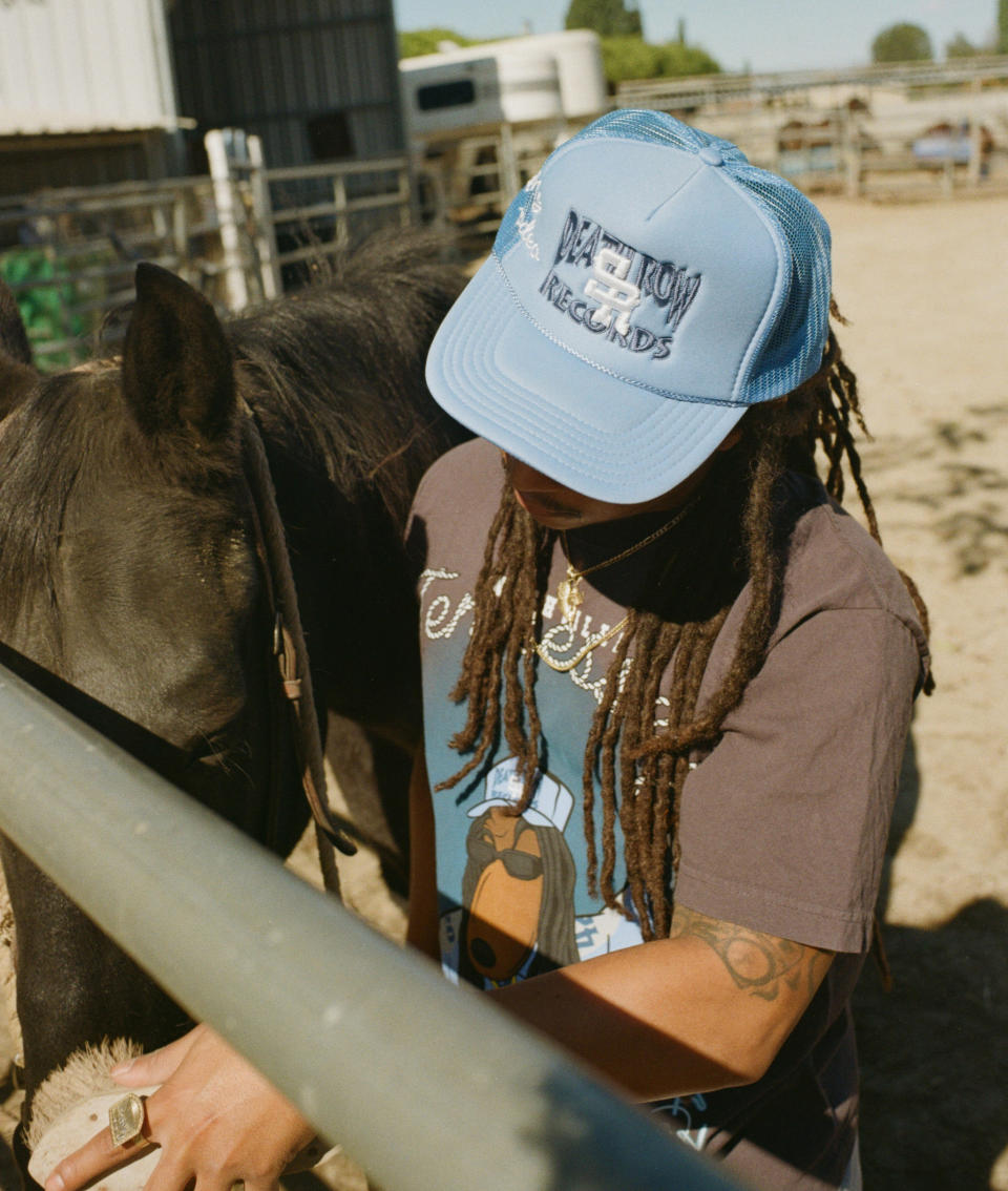 Another shot of a Compton Cowboy wearing the collab's t-shirt and hat