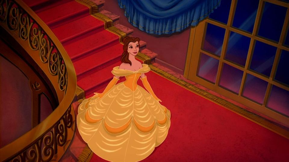 Belle coming down the stairs with her iconic yellow dress in Beauty and the Beast