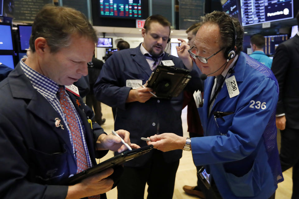 Traders Robert Charmak, Michael Milano, and Steven Kaplan, left to right, work on the floor of the New York Stock Exchange, Friday, Dec. 28, 2018. Stocks are opening higher Friday as U.S. markets try to maintain the momentum from a late-day rally on Thursday. (AP Photo/Richard Drew)