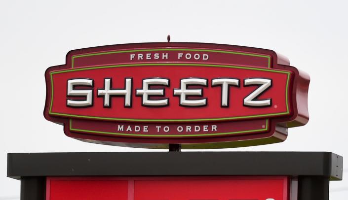 A red sign with white lettering that reads &quot;Sheetz,&quot; &quot;Fresh food,&quot; and &quot;Made to Order&quot; against an overcast sky at a Sheetz location in Cumru Township, Pennsylvania.