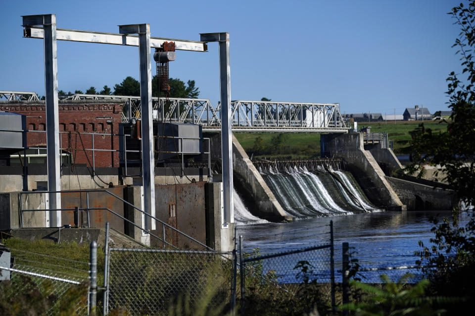 The Shawmut dam spans the Kennebec River, Tuesday, Sept. 14, 2021, in Fairfield, Maine. The dam, which owned by Brookfield Renewable partners, a Canadian energy company, had been slated to be removed from the Kennebec River but is now up for relicensing. The Sappi paper mill says its 735 employees would lose their jobs if the dam no longer held back enough water to meet the mill's needs. (AP Photo/Robert F. Bukaty)