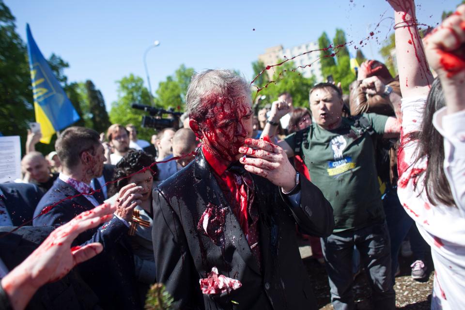 Protesters threw red paint on the Russian Ambassador to Poland, Ambassador Sergey Andreev, as he arrived at a cemetery in Warsaw to pay respects to Red Army soldiers who died during World War II.