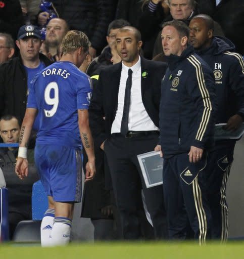 Chelsea's Spanish striker Fernando Torres (L) trudges past Chelsea's Italian manager Roberto Di Matteo after was sent off during the English Premier League football match between Chelsea and Manchester United at Stamford Bridge on October 28. Manchester United won the game 3-2