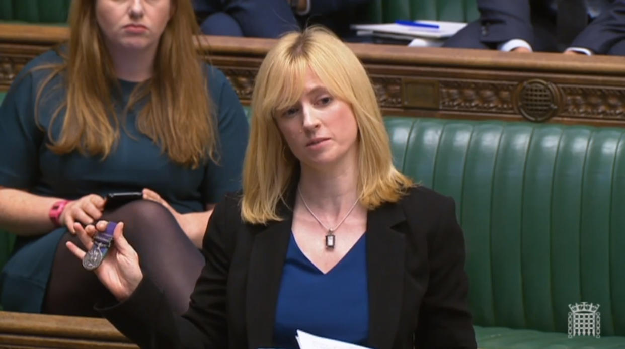 Labour MP for Canterbury, Rosie Duffield, holds up a medal from one of her constituents in the House of Commons in London.