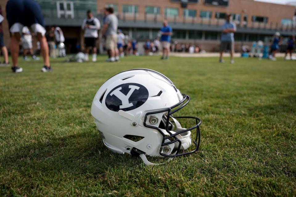 A helmet is pictured on the grass after BYU football practice at Brigham Young University in Provo on Tuesday, Aug. 1, 2023. | Spenser Heaps, Deseret News