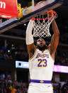 Los Angeles Lakers forward LeBron James dunks against the Denver Nuggets during the first quarter an NBA basketball game Tuesday, Dec. 3, 2019, in Denver. (AP Photo/Jack Dempsey)