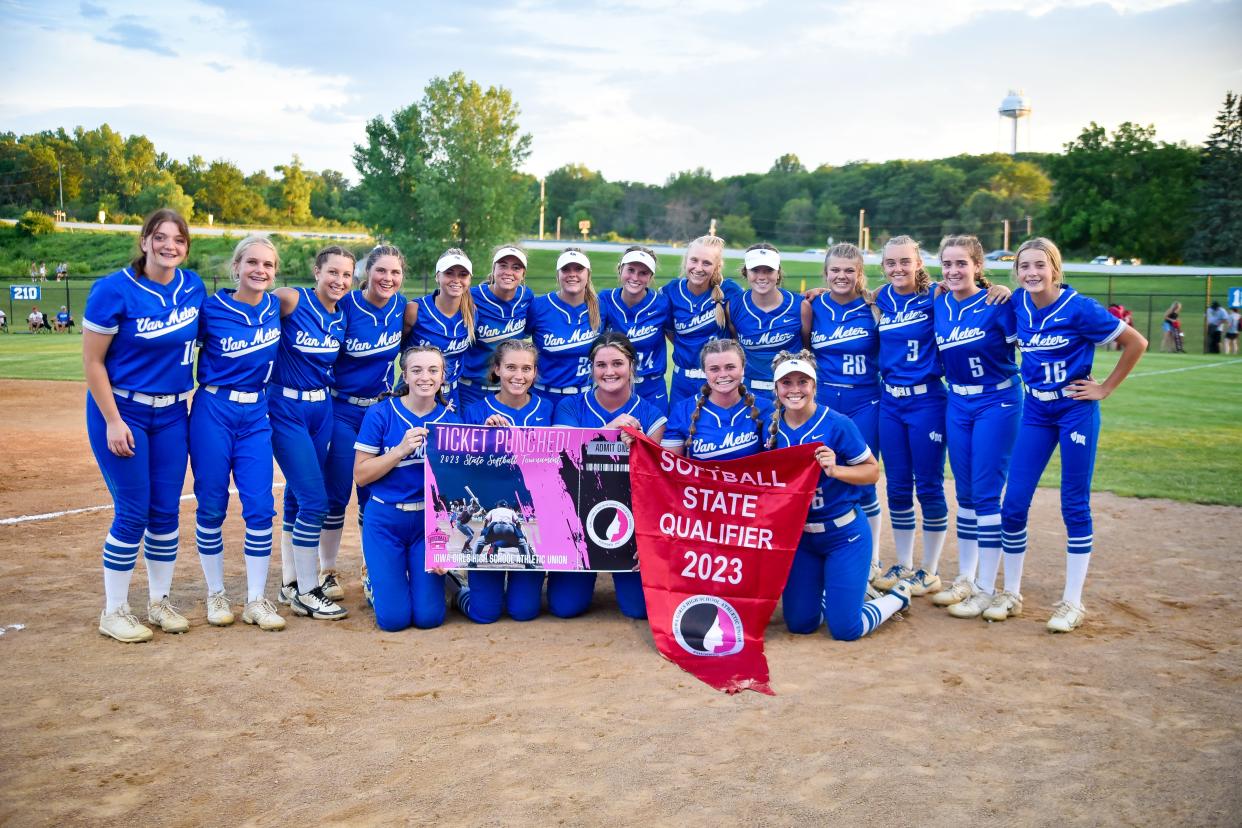 Van Meter players celebrate with their state qualifier banner after a Class 2A regional final softball game against Pocahontas Area on Monday, July 10, 2023, in Van Meter.
