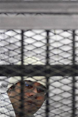 Political activist Ahmed Maher of the 6 April movement looks on behind bars in Cairo, December 22, 2013. REUTERS/Stringer