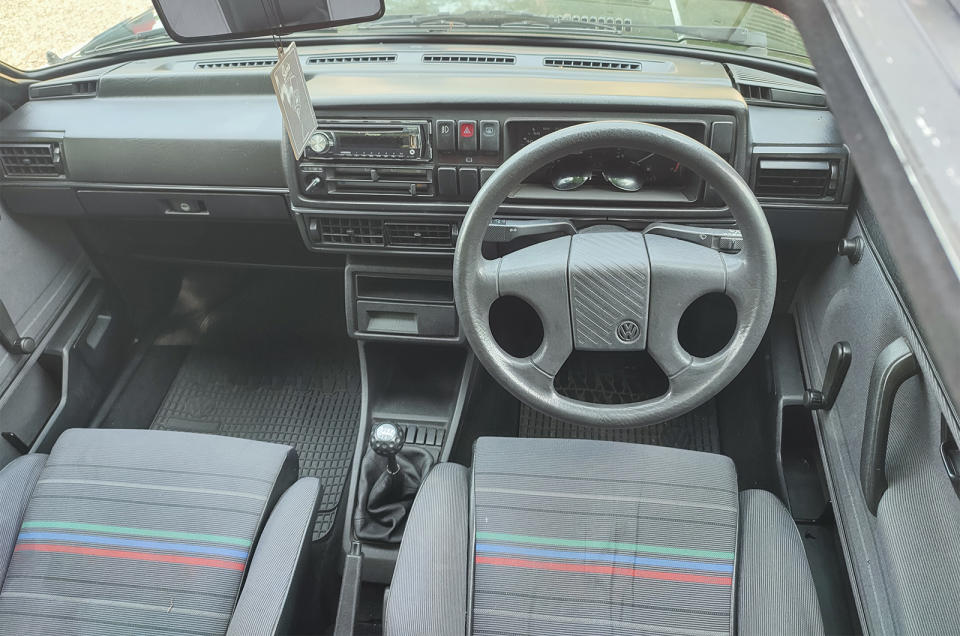 <p>Through this 1988 car's generous sunroof we spied some fantastic original bucket seats and a characterfully blocky dashboard, which still manages to be interesting in 50 shades of grey. </p>