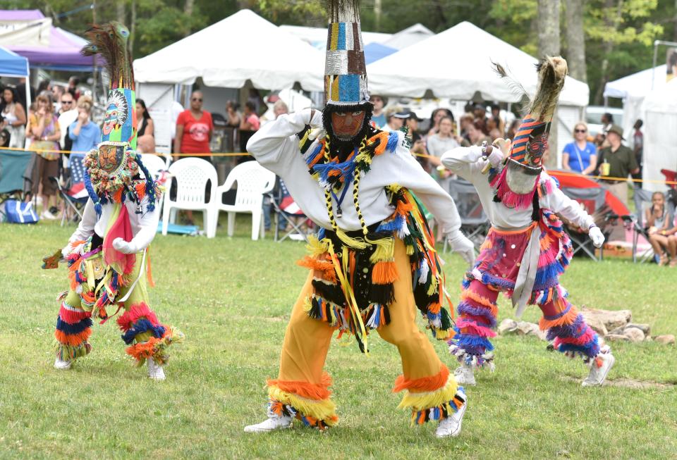 Bermuda Gombey dancer Ivan Trott, center, leads some of the ceremonial dances at the 98th annual Mashpee Wampanoag Tribe Powwow on tribal lands.