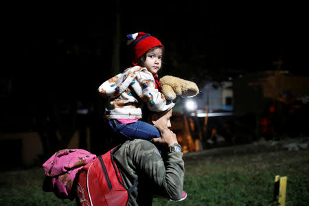 People belonging to a caravan of migrants from Honduras en route to the United States, walk at the border crossing to Mexico in Hidalgo, Mexico, January 18, 2019. REUTERS/Jose Cabezas