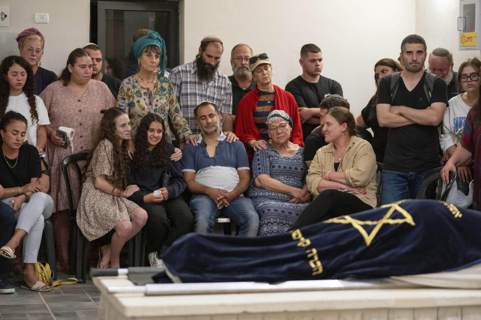 Mourners attend the funeral of Batsheva Nigri, at a cemetery in the West Bank Jewish settlement of Kfar Etzion, Monday, Aug. 21, 2023. Israeli authorities say that a suspected Palestinian attacker has killed an Israeli woman and seriously wounded a man in the incident. (AP Photo/Ohad Zwigenberg)