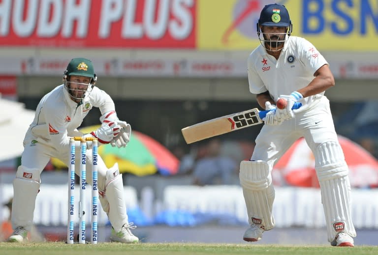 Indian batsman Murali Vijay plays a shot as Australian wicketkeeper Matthew Wade looks on on the third day of their 3rd Test match, at the Jharkhand State Cricket Association (JSCA) Stadium complex in Ranchi, on March 18, 2017